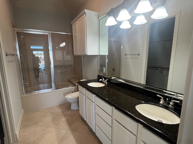 full bathroom with tile patterned floors, vanity, toilet, and enclosed tub / shower combo