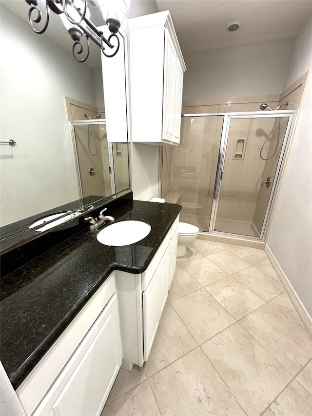 bathroom with vanity, toilet, and walk in shower