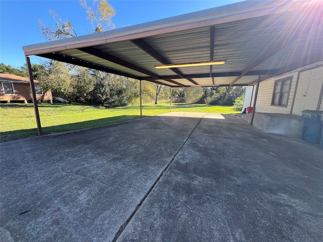 view of vehicle parking with a carport and a yard