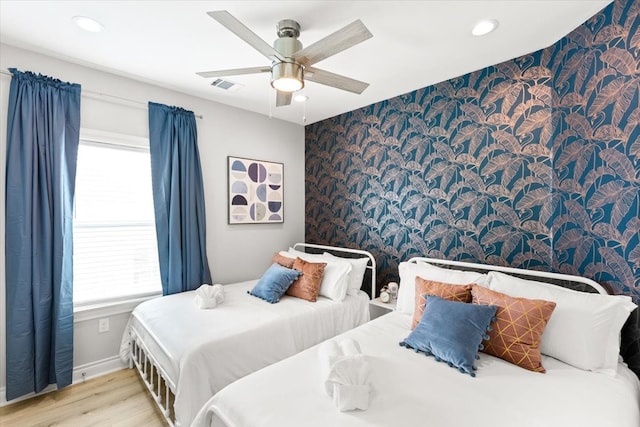 bedroom with ceiling fan and light hardwood / wood-style flooring