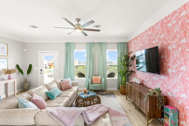 living room with ceiling fan, light hardwood / wood-style flooring, and ornamental molding