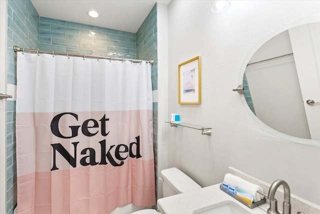 bathroom with a shower with curtain, vanity, and toilet