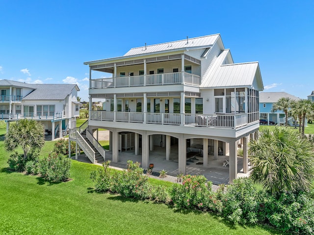 rear view of property featuring a yard and a carport