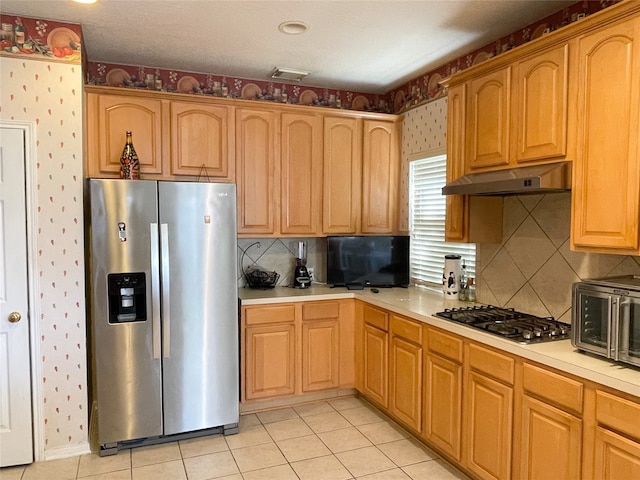 kitchen featuring light tile patterned floors and appliances with stainless steel finishes