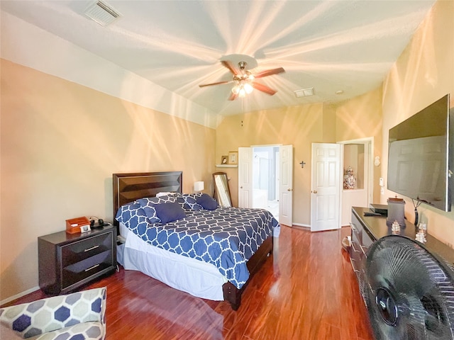 bedroom featuring ceiling fan, dark hardwood / wood-style flooring, and vaulted ceiling