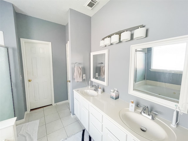 bathroom featuring a bath, vanity, and tile patterned floors