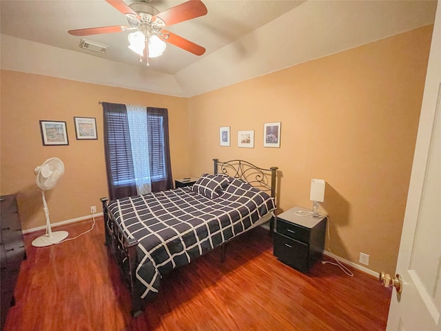 bedroom featuring ceiling fan, wood-type flooring, and vaulted ceiling