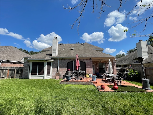 back of house featuring a yard and a patio