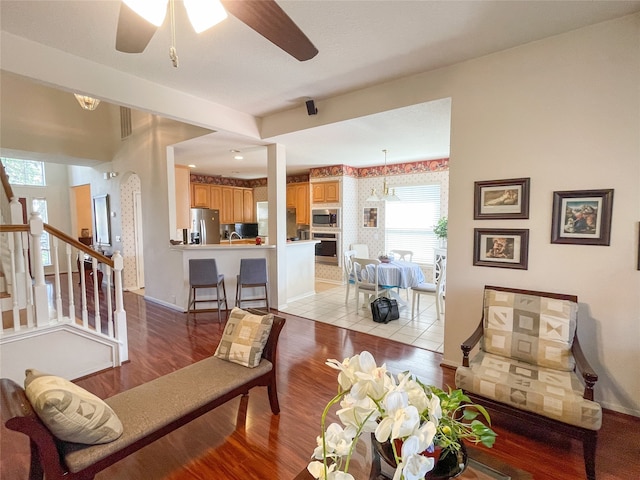 living room featuring ceiling fan and light hardwood / wood-style floors