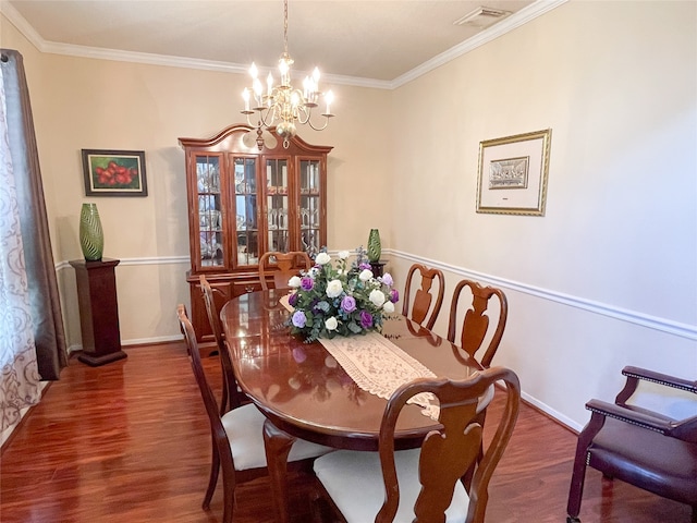 dining area featuring a chandelier, dark wood-type flooring, and ornamental molding