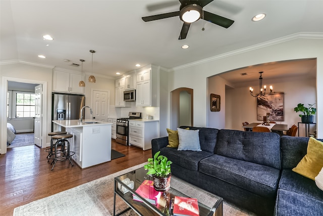 living room featuring dark hardwood / wood-style floors, crown molding, and lofted ceiling