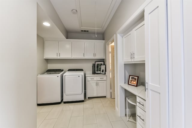 laundry area with washer and dryer and cabinets