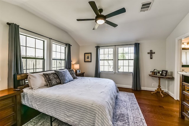 bedroom featuring ceiling fan, dark hardwood / wood-style flooring, and vaulted ceiling