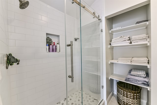 bathroom featuring a shower with door