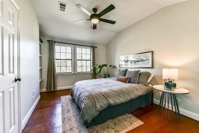 bedroom with vaulted ceiling, ceiling fan, and dark hardwood / wood-style floors