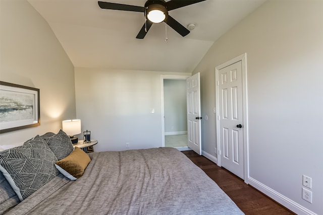 bedroom featuring dark hardwood / wood-style floors, vaulted ceiling, and ceiling fan