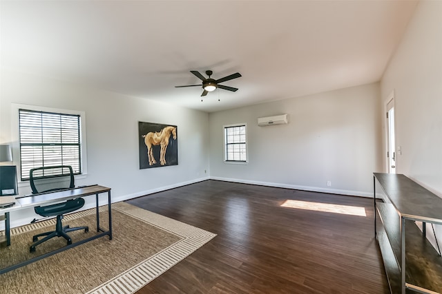 office featuring dark hardwood / wood-style flooring, a wall unit AC, and ceiling fan