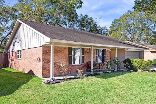 single story home with a front yard and a garage