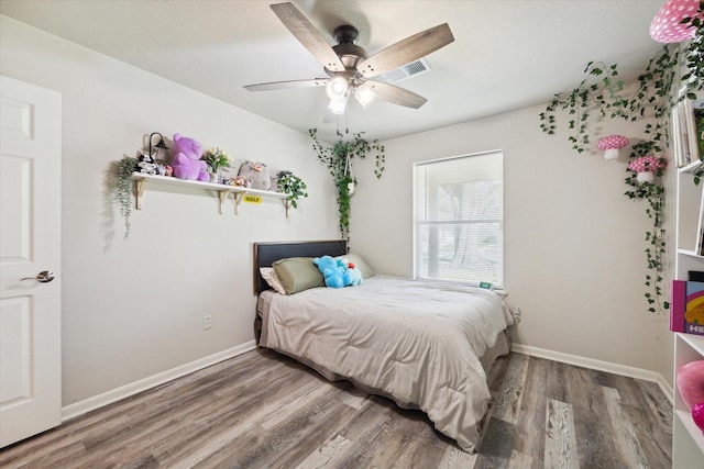 bedroom with hardwood / wood-style floors and ceiling fan