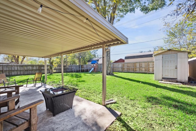 view of patio featuring a playground and a storage unit