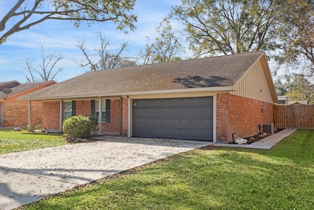 ranch-style house with central AC unit, a garage, and a front yard