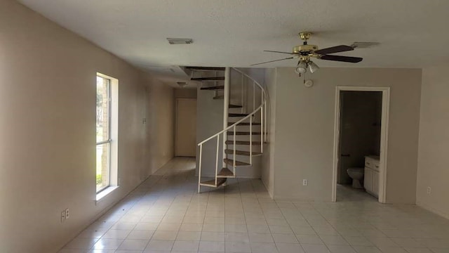 interior space with ceiling fan