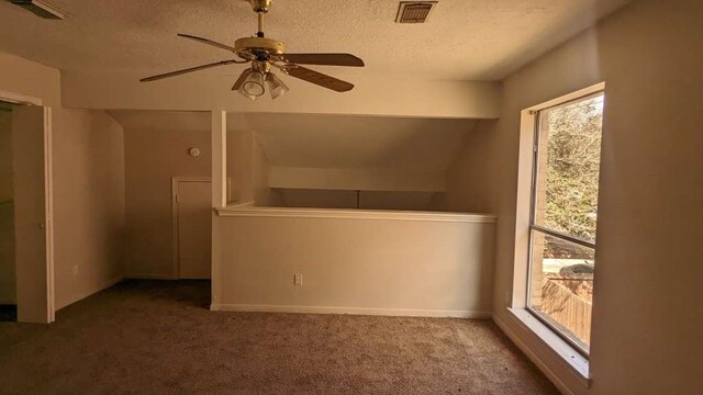 unfurnished bedroom with carpet flooring, ceiling fan, and a textured ceiling