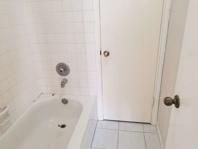 bathroom featuring tile patterned flooring and tiled shower / bath combo