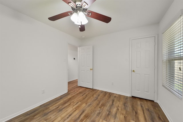 unfurnished bedroom with hardwood / wood-style floors and ceiling fan