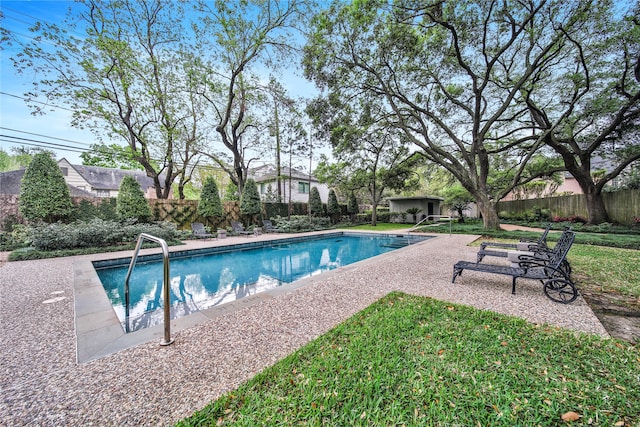 view of swimming pool with a yard and a patio