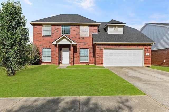 view of front of property featuring a garage and a front lawn