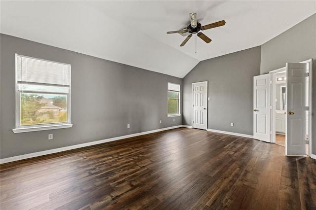 empty room with dark hardwood / wood-style floors, ceiling fan, and lofted ceiling