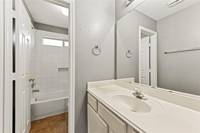 bathroom featuring washtub / shower combination, vanity, and tile patterned floors