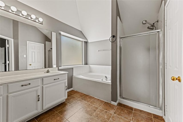 bathroom featuring tile patterned flooring, vanity, separate shower and tub, and lofted ceiling