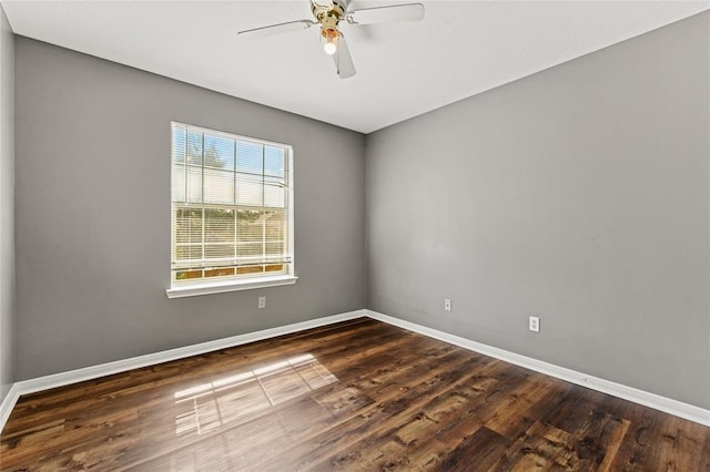 empty room featuring ceiling fan and dark hardwood / wood-style flooring