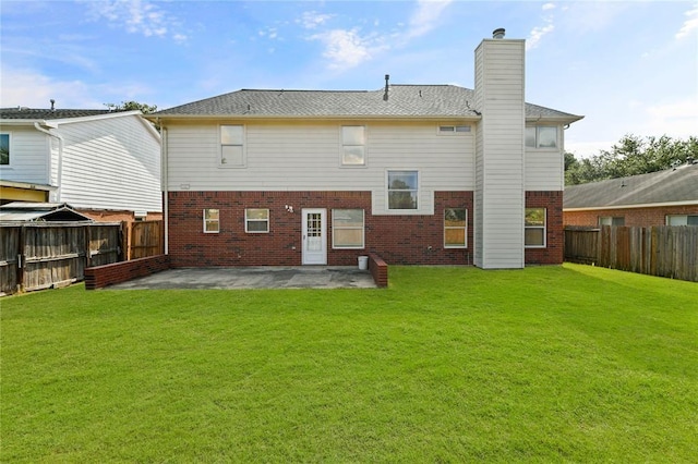 rear view of house featuring a patio area and a lawn