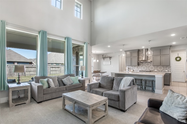 carpeted living room with plenty of natural light and a towering ceiling