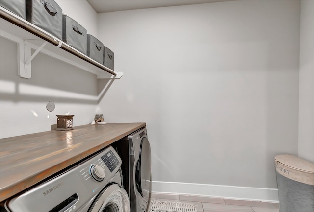 laundry area featuring light tile patterned flooring and independent washer and dryer