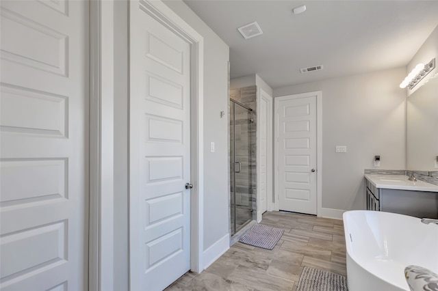 bathroom featuring plus walk in shower and vanity