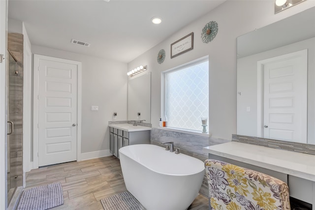 bathroom featuring separate shower and tub, plenty of natural light, vanity, and wood-type flooring