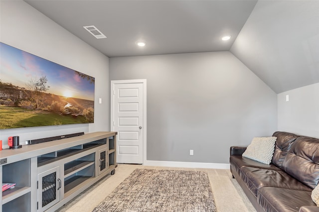 carpeted living room featuring lofted ceiling