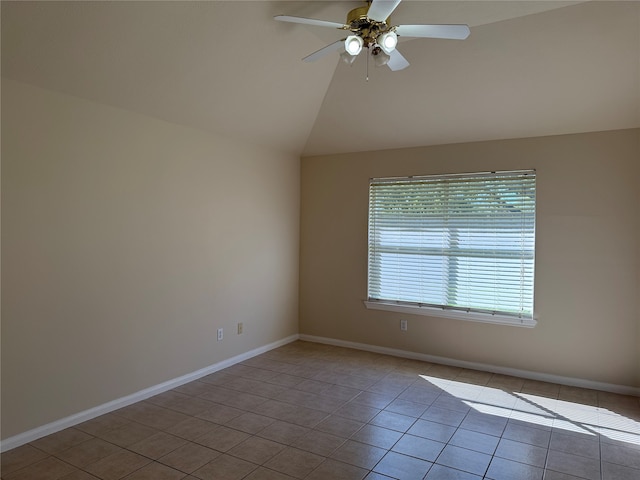 tiled empty room featuring ceiling fan and vaulted ceiling