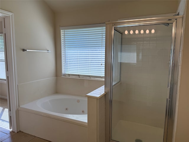 bathroom featuring tile patterned flooring and shower with separate bathtub