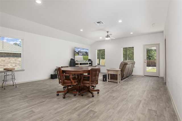 dining area featuring ceiling fan, a healthy amount of sunlight, vaulted ceiling, and light hardwood / wood-style flooring