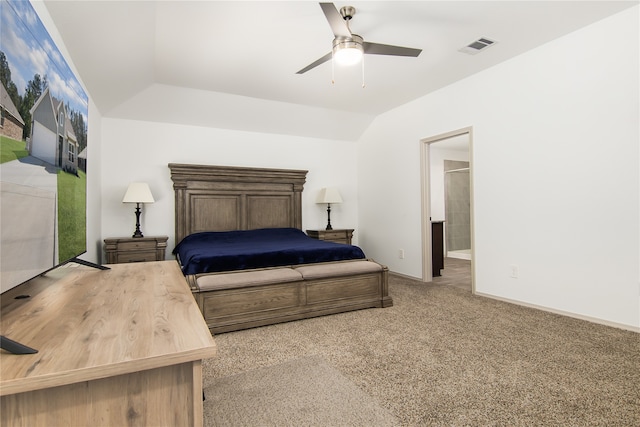 bedroom with carpet flooring, ensuite bathroom, vaulted ceiling, and ceiling fan