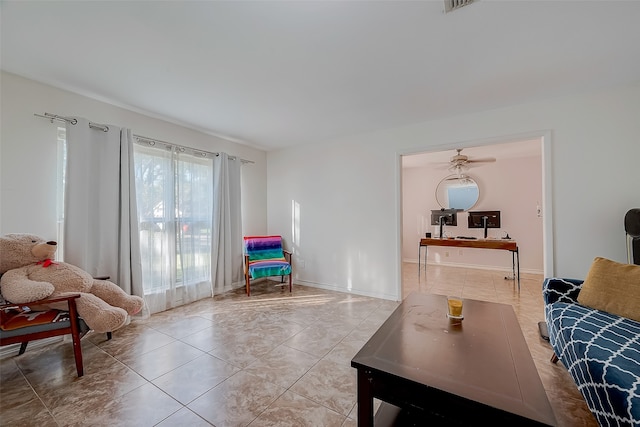 tiled living room with ceiling fan