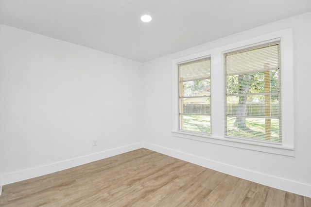 empty room with hardwood / wood-style floors