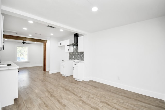 unfurnished living room featuring beam ceiling, light wood-type flooring, and ceiling fan