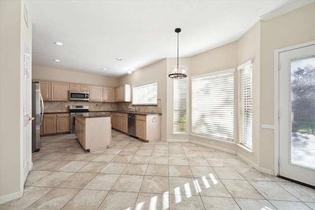 kitchen with pendant lighting, decorative backsplash, light brown cabinetry, light tile patterned floors, and appliances with stainless steel finishes