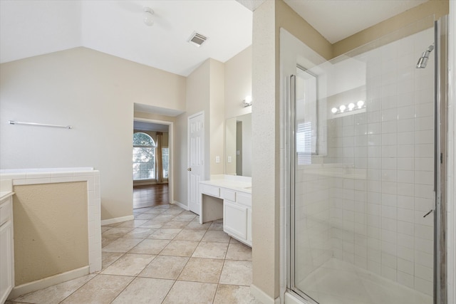 bathroom featuring tile patterned flooring, vanity, vaulted ceiling, and an enclosed shower